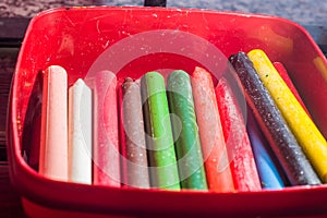 colored crayons, various colors of crayons on a wooden table with natural light and background window, diversity