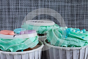 Colored cupcakes close-up on grey fabric background