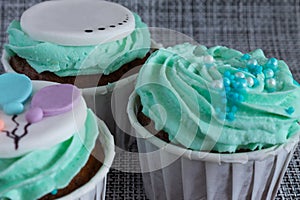 Colored cupcakes close-up on grey fabric background