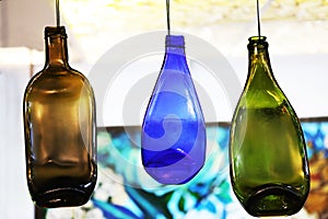 Colored, decorative bottles hang on a rope. Interior Design. Close-up