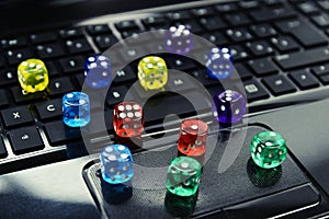 Colored dices on keyboard - on line gambling concept