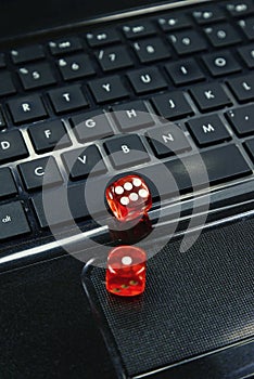 Colored dices on keyboard - on line gambling concept