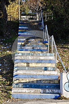 Colored, dilapidated steps with white fence