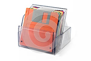 Colored diskettes in a transparent box.