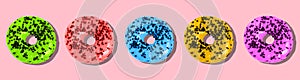 Colored donuts on a pink background. Sweet doughnut with icing