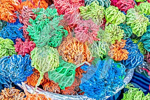 Colored dried seaweed Rose of Jericho (Selaginella lepidophylla) shaped into decorative balls on the street market