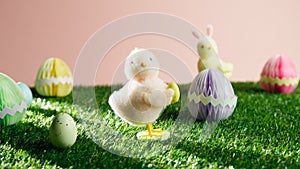 Colored Easter eggs with chicks in the garden