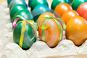 Colored Easter eggs in egg carton holder