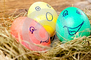 Colored Easter eggs with painted faces.