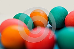 Colored easter eggs on plate on a white background