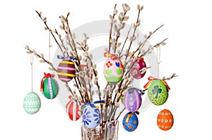 Colored easter eggs on willow bouquet with willows