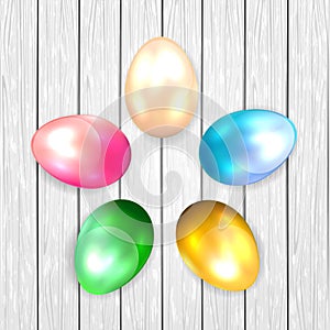 Colored Easter eggs on wooden background