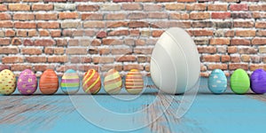 Colored easter eggs on the wooden table and brick wall in the background