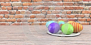 Colored easter eggs on the wooden table and brick wall in the background.