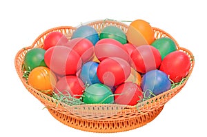 Colored easter romanian traditional eggs in a brown basket, close up, isolated, white background.