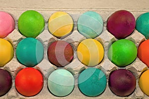 Colored eggs in carton