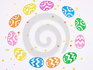 Colored eggs composition flat lay on white background, close up