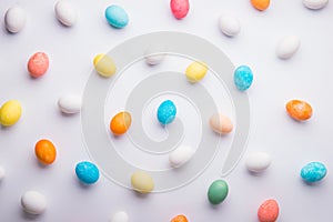 Colored eggs flat lay on a white background. Easter and spring composition.