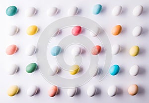 Colored eggs flat lay on a white background. Easter and spring composition.