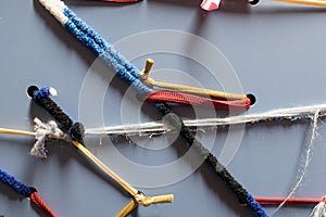 Colored elastic cotton strips interlaced on a metal panel as dec