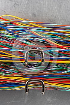 Colored electric cable on hooks of organizer