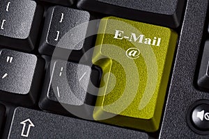 Colored Email button on black computer keyboard. Internet online business communication concept.