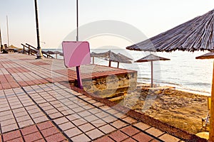 Colored empty wooden board for beach advice at Sunrise