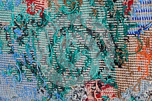 Colored fabric background from embroidered threads on a piece of old clothes