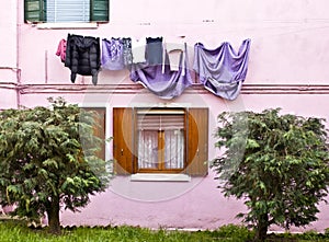 Colored facade in Burano with laundry hanging in the sun