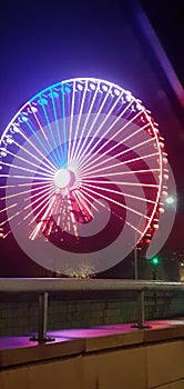 Colored ferris wheel in the night