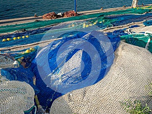 Colored fishing net with floats in industrial port