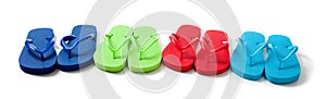 Colored flipflops on a white background