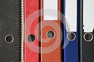 Colored folders for office files and paper on a shelf. Background image