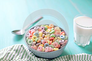Colored fruit grain loops with a glass of milk on the table. breakfast concept