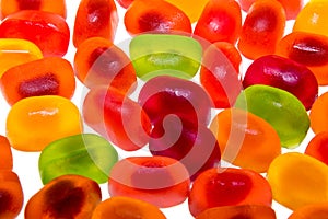 Colored fruit jelly beans on white background