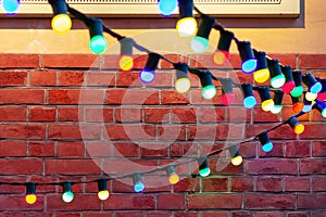 Colored garland on a brick wall. design stonewall brickwork