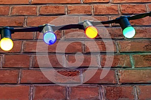 Colored garland on a brick wall. design stonewall brickwork