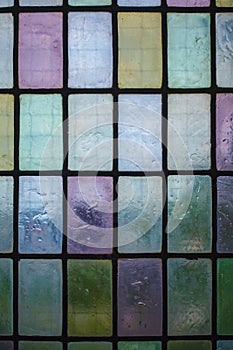 Colored glass window with block pattern background