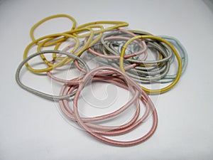 colored hair ties can be used by men or women on a white background