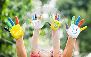 Colored hands with smile painted in colorful paints