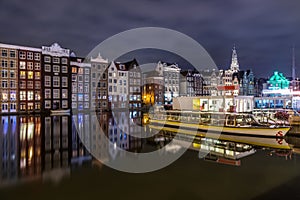 Colored homes on the water in Amsterdam at night