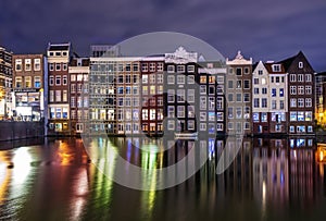 Colored homes on the water in Amsterdam at night