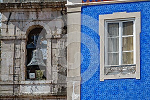 Colored house with window and belfy in the background