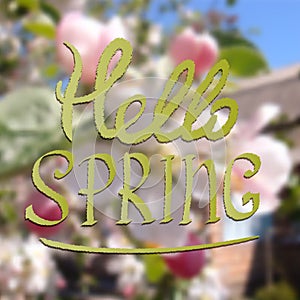 Colored illustration with chalk drawn text ''hello spring'' on blurred background with blooming tree.