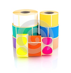 Colored label rolls isolated on white background with shadow reflection. Color reels of labels for printers.