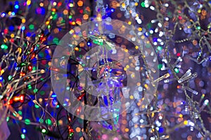 Colored lights Christmas different garlands hanging in a row shop.