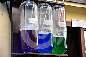 Colored liquids in three test tubes. pharmacy or medical store decor. outdoor