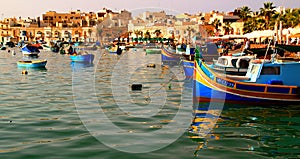 Colored luzzu fishing boats in the port of Marsaxlokk on the Island of Malta