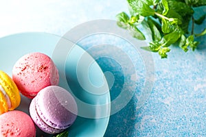 Colored macaroons. Delicious sweet colorful French desserts on light background