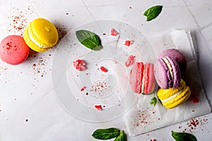 Colored macaroons. Delicious sweet colorful French desserts on light background